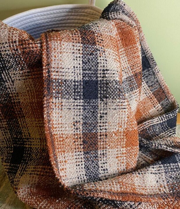 Brown check throw blanket made from fabric destined for landfill. This eco conscious sofa throw is also a great picnic blanket and chilly summer evenings. We think you will love it!