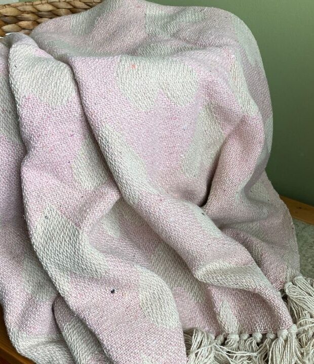 This pink eco throw blanket from Neith Textiles is woven from recycled cotton. These eco friendly soft furnishings are perfect to cover sofas and to give any room a new look