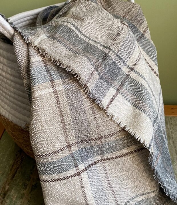 Soft grey picnic blanket made from rescued fabric. Perfect to give any room a new look. Add elegance to your living space with this sumptuous throw blanket.